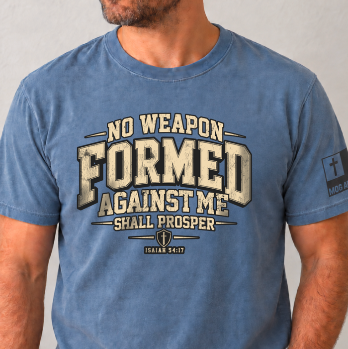 Blue Jean Comfor Colors Tee with No Weapon Formed Against Me Shall Prosper printed on the front and the MOG Apparel Flag Logo on the left sleeve.